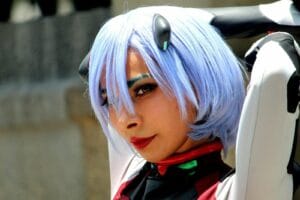 Portrait of a woman in anime cosplay with blue wig and costume, showcasing artistic expression.