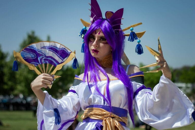 Character Ai Romance Roleplay Ideas 24 Colorful Cosplay Character In Detailed Costume With Purple Wig And Fan Outdoors.