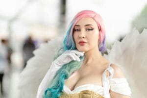 Colorful angelic cosplay with pastel hues capturing fantasy art at San José convention.