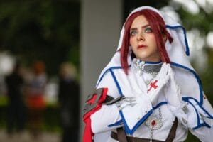 Cosplay artist dressed in intricate costume at a convention in San José.