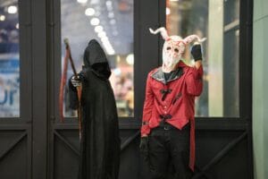 Two cosplayers in detailed costumes at an anime event in San José, Costa Rica.