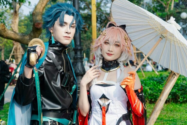 Character Ai Conversation Flow Guide 16 Two Cosplayers In Vibrant Costumes Posing With A Parasol Outdoors.