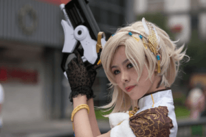 Cosplayer with intricate costume and prop gun, posing outdoors during the day.